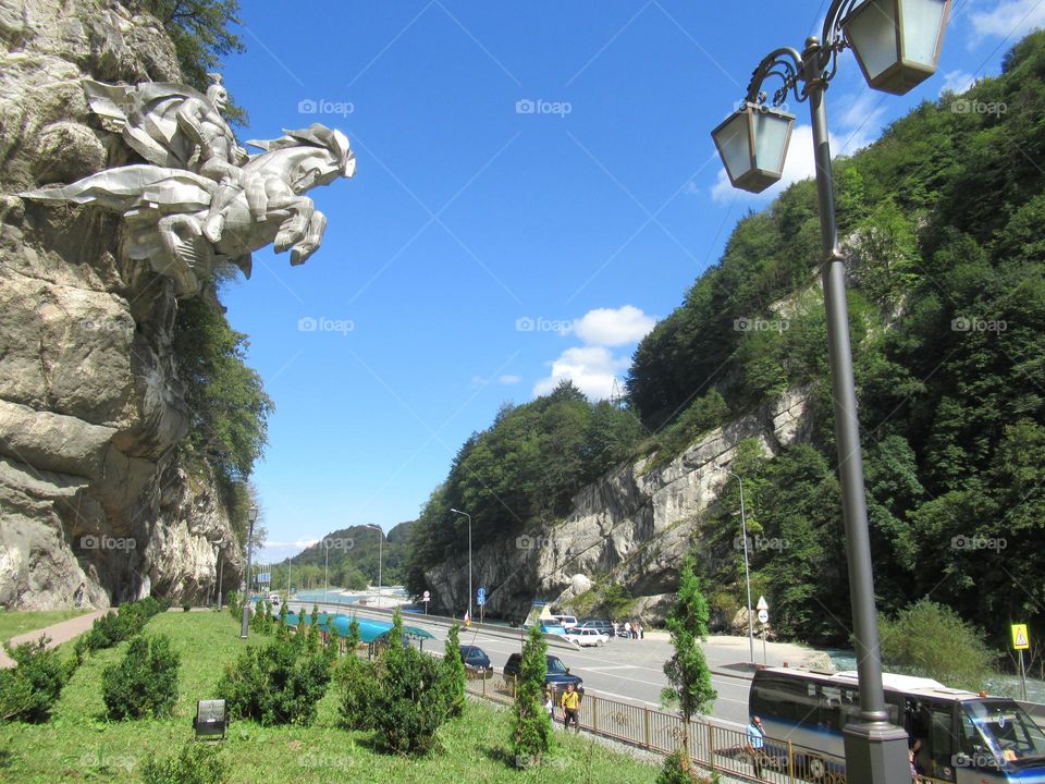 monument, image of St. George the Victorious on a horse on a rock in the mountains of Ossetia, North Caucasus, Russia road, travel, pilgrims