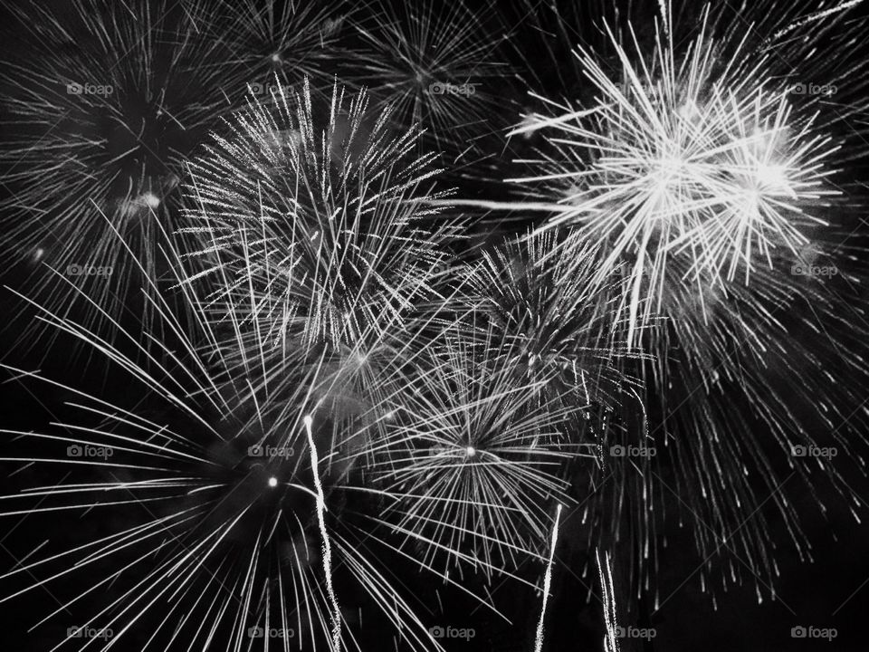 The beautiful lines of bursting fireworks in the night sky.