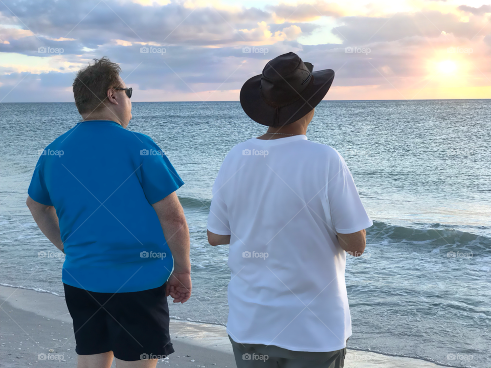 Brothers sharing the tranquility of the sunset.