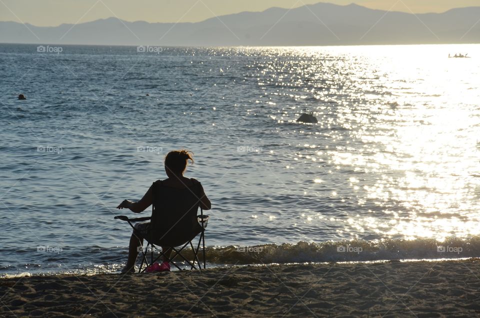 A woman looking at the view. Who knows where it's going?
