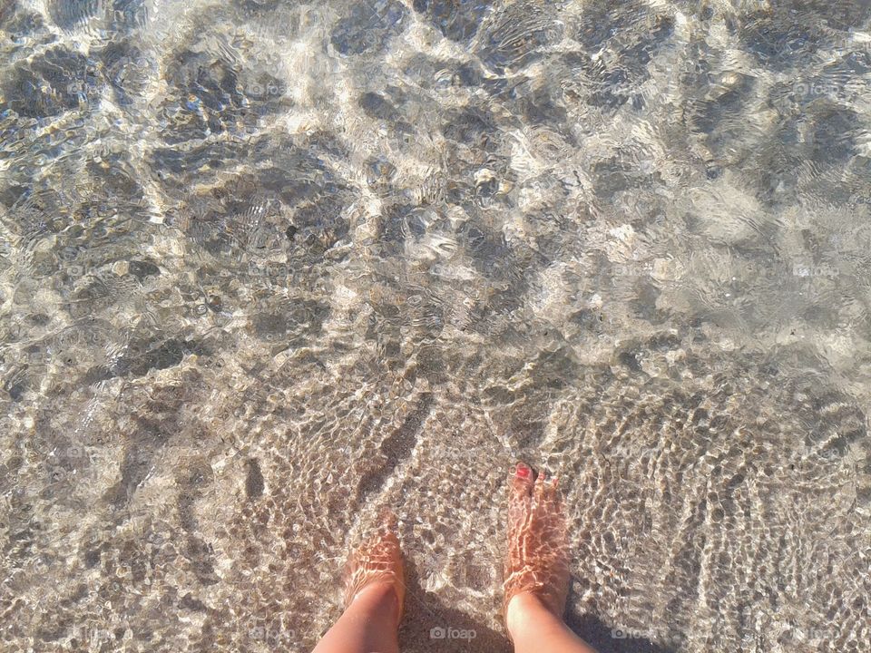 Lower section of woman's leg in water