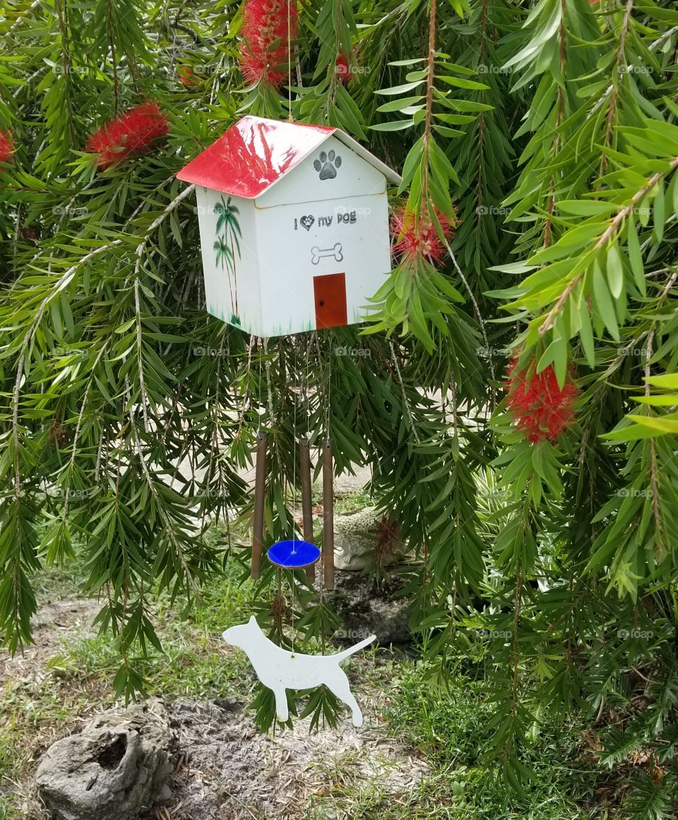 Red roof dog house windchime in the bottle brush