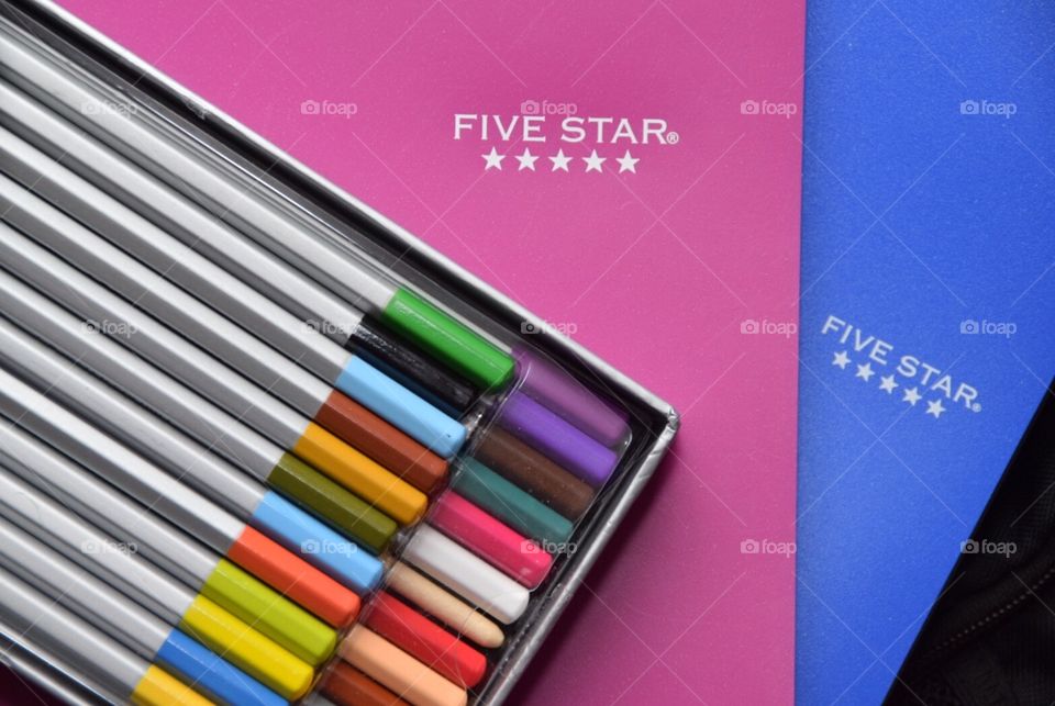 Five star spiral notebook and three ring binder, in blue and magenta with colored pencils