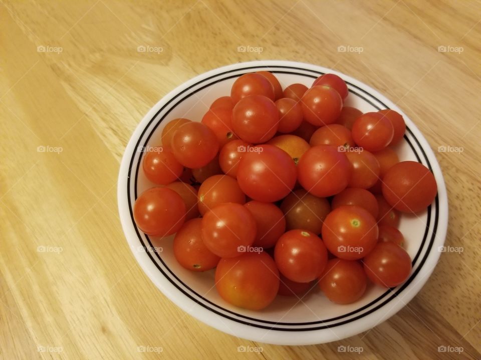 Fresh homegrown cherry tomatoes picked from backyard garden in Hilo Hawaii.