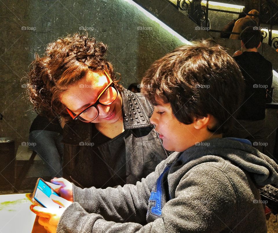 Close-up of a boy using mobile phone