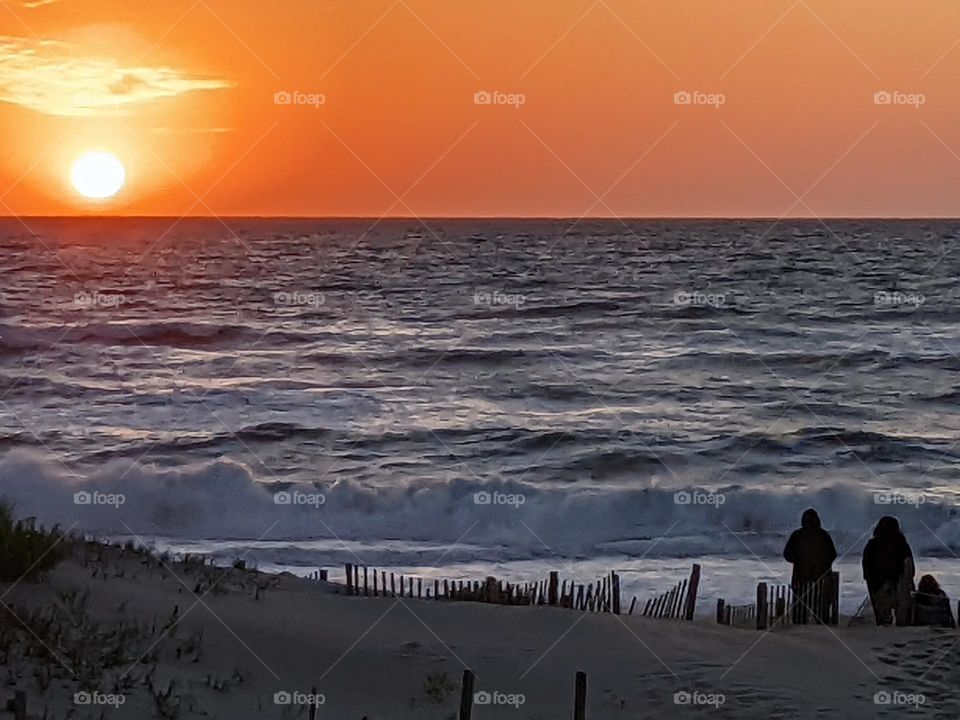 Sunrise at Outer Banks in North Carolina with a young couple on the beach