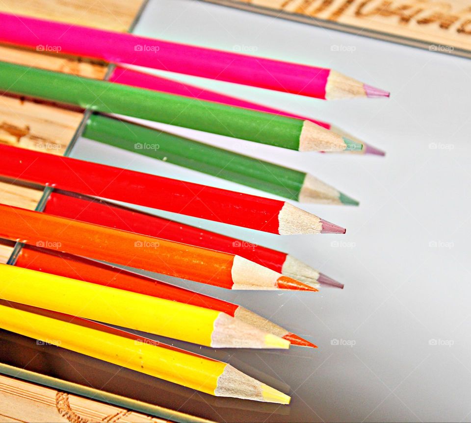 reflections of colorful wooden pencils