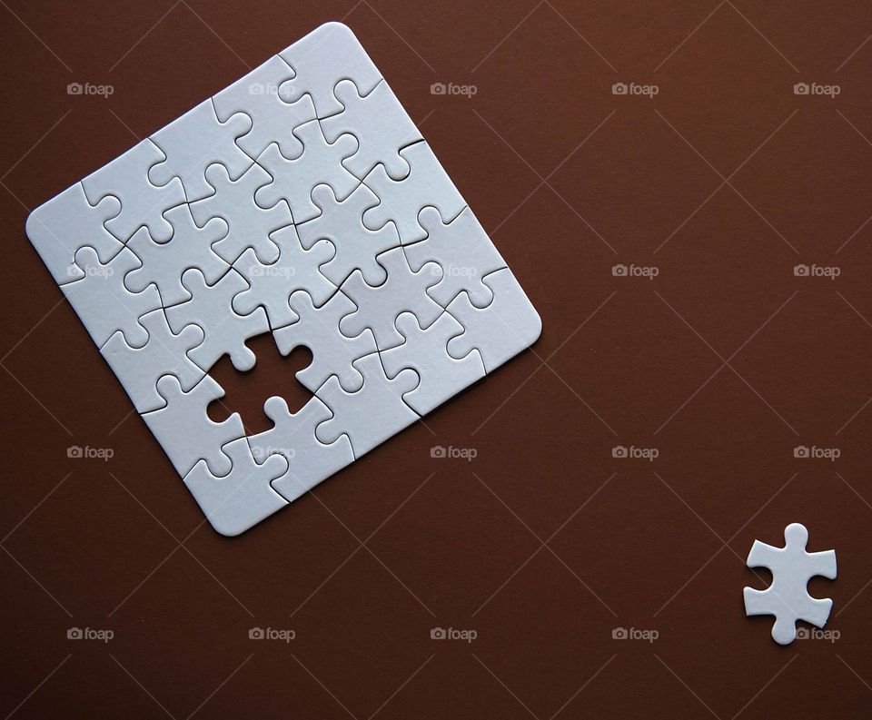 White details of puzzle on brown background