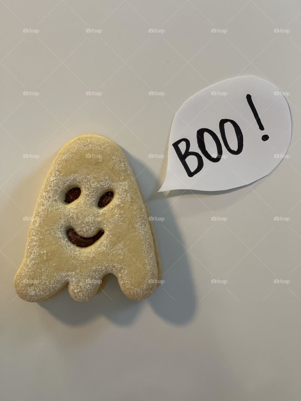 Halloween ghost shaped freshly baked cookie with comic balloon boo ! 