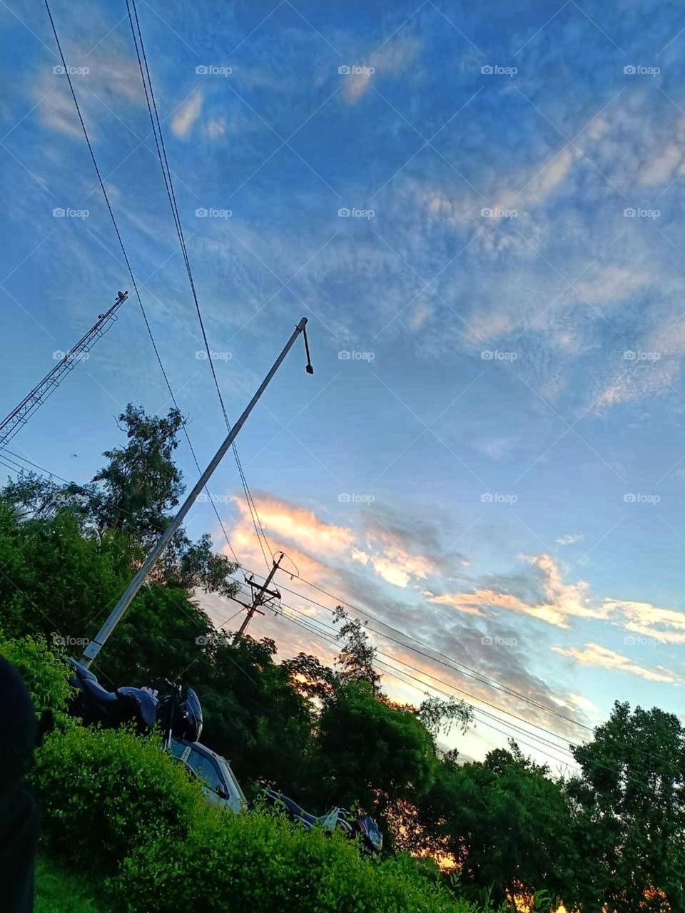 The sky at sunset with those clouds looks absolutely stunning! It's like a painting in the sky. 🌅✨