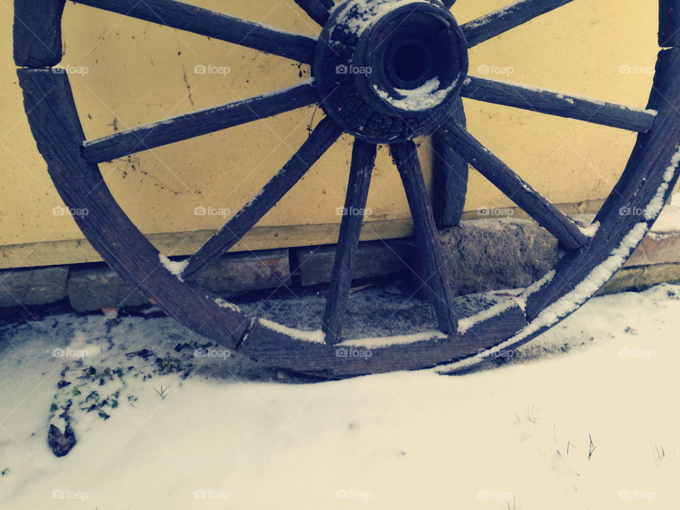 old wooden wheal and snow
