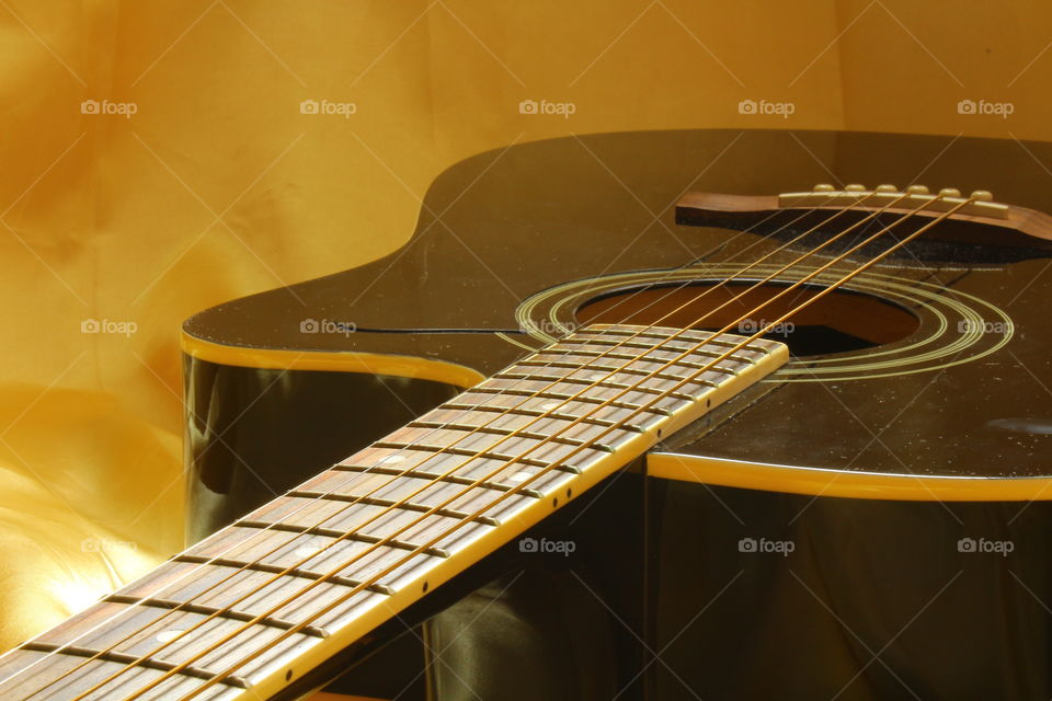 acoustic guitar on Golden textile