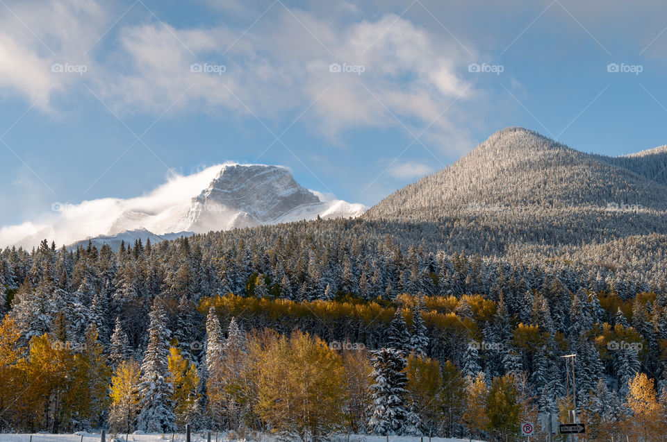 sunset sun at the peaks of the Rocky mountains at Banff national park in autumn season.