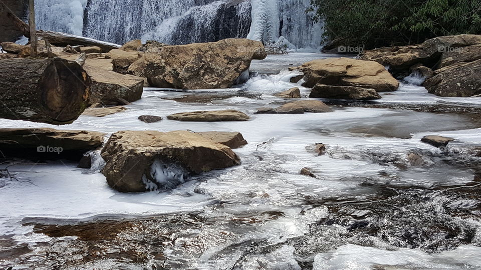 frozen water over rocks