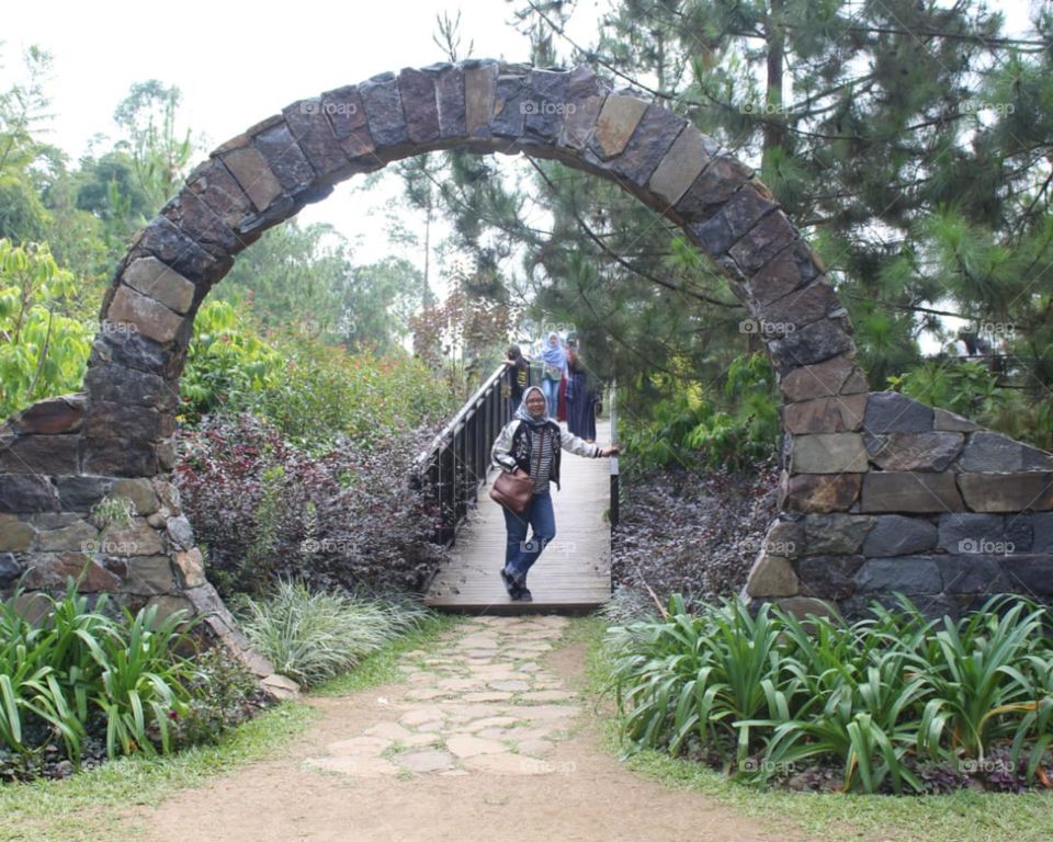a woman in the middle of a stone circle
