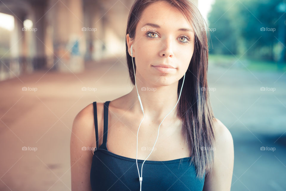 beautiful young woman listening music with earphones