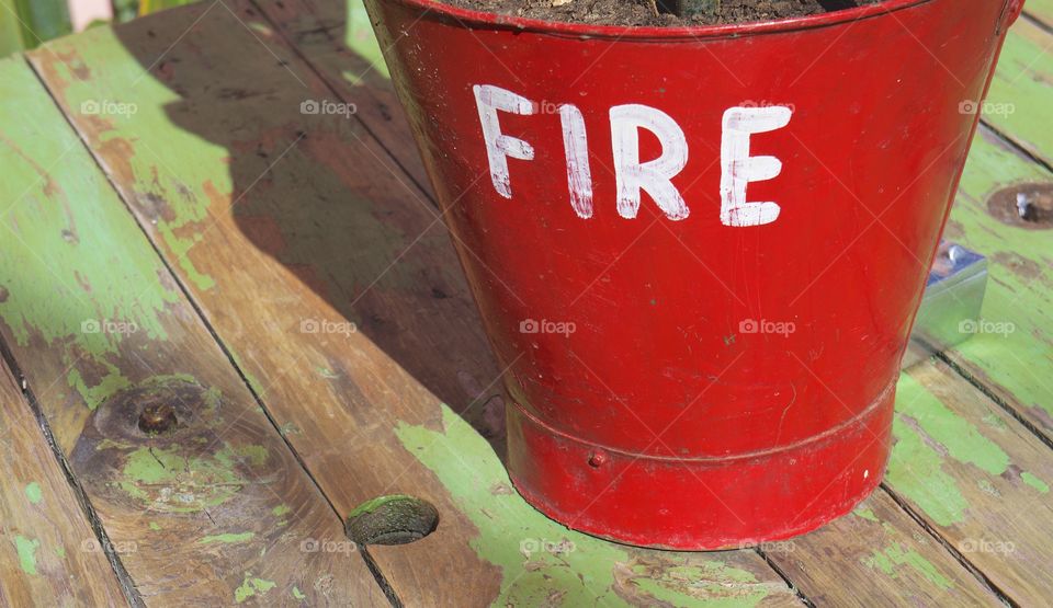 A red colorful planter on a wooden planter in San Miguel de Allende, Mexico