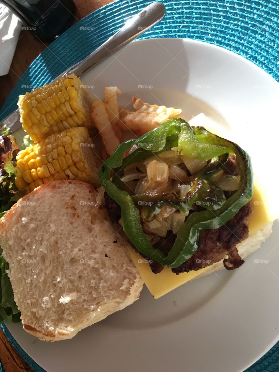 Grilled turkey burger with all the healthy trimmings, grilled corn on the cob