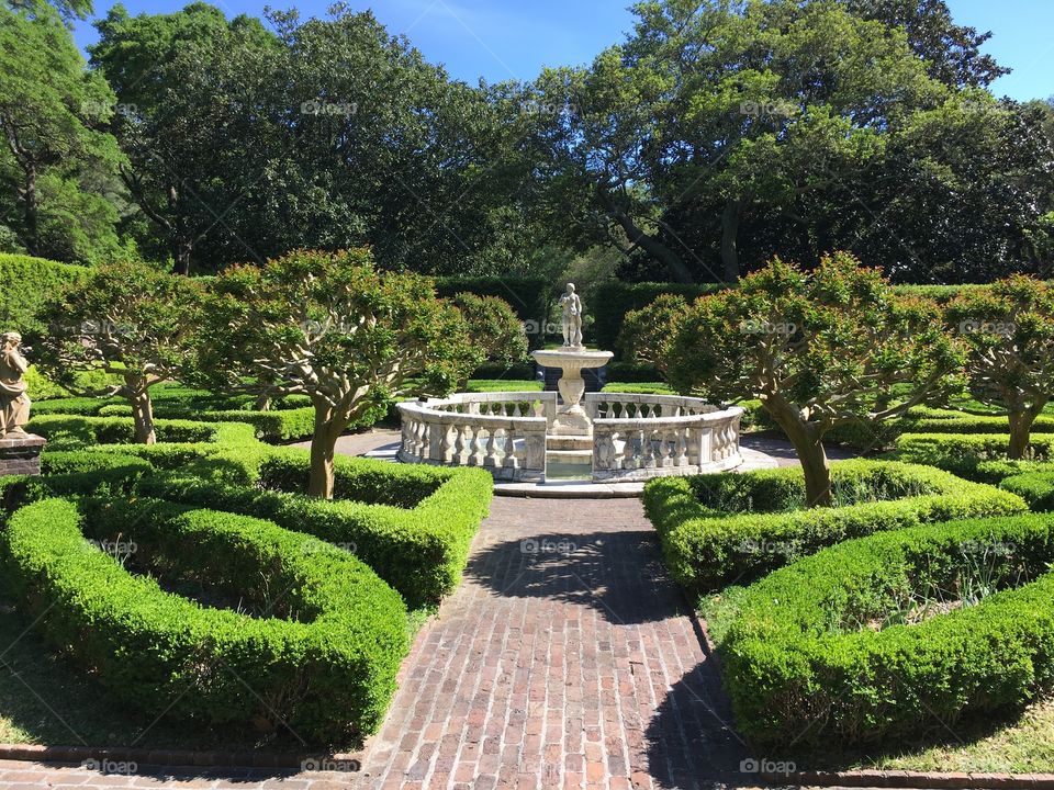 Elizabethan Gardens walkway with statue Manteo, NC