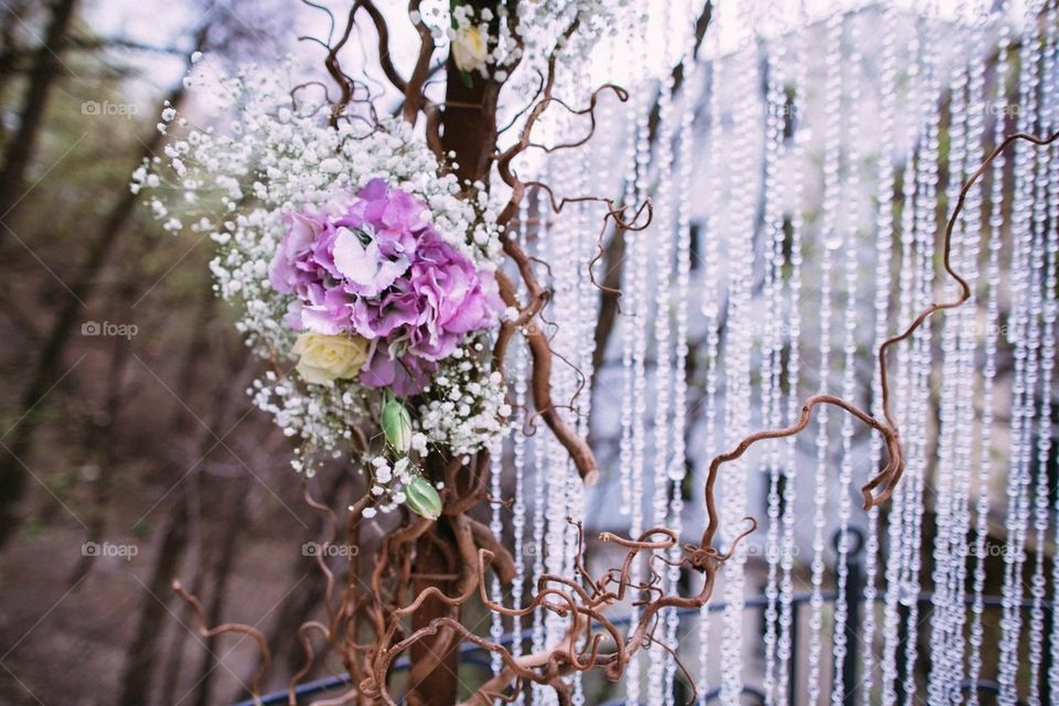 A part of a wedding flower arch. A refined floral composition with cascading strands of glass beads. Perfect as a background 