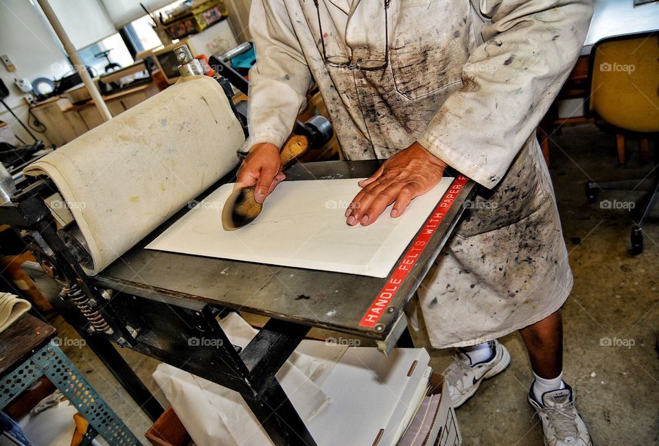 Man making ink block prints