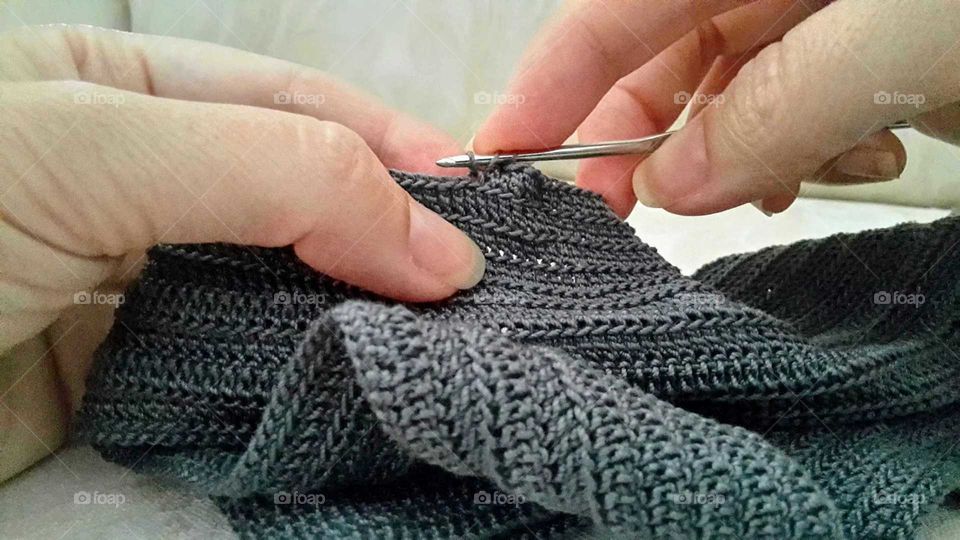 Close-up of person hand knitting