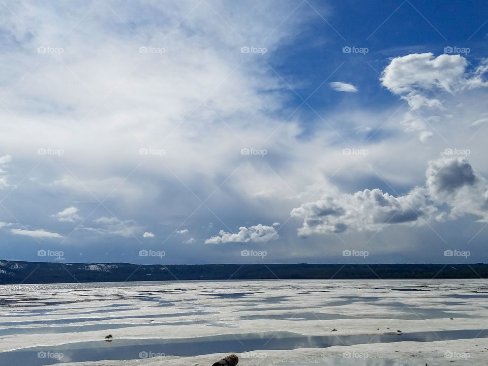 sun melting the snow and ice on a lake in Wyoming