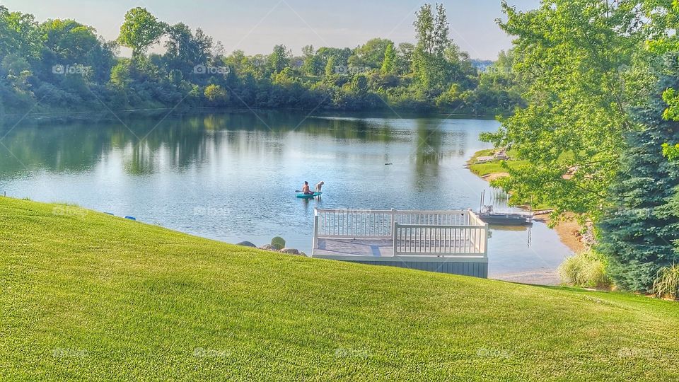 paddleboad alone on lake with dog