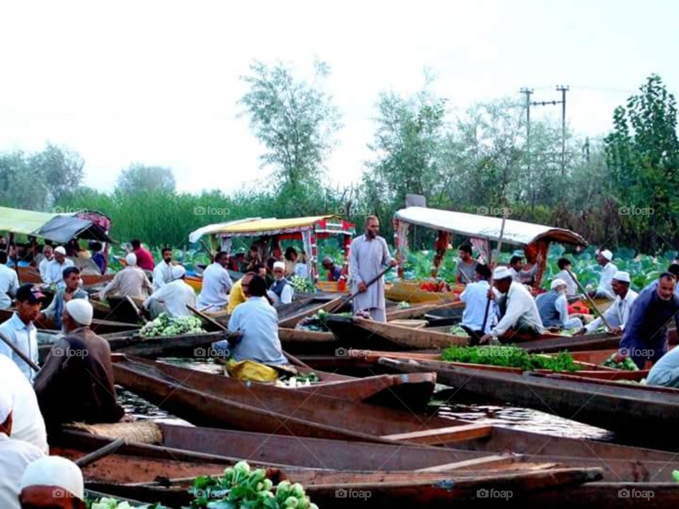 Traders arriving at floating market Dal Lake Srinagar Kashmir