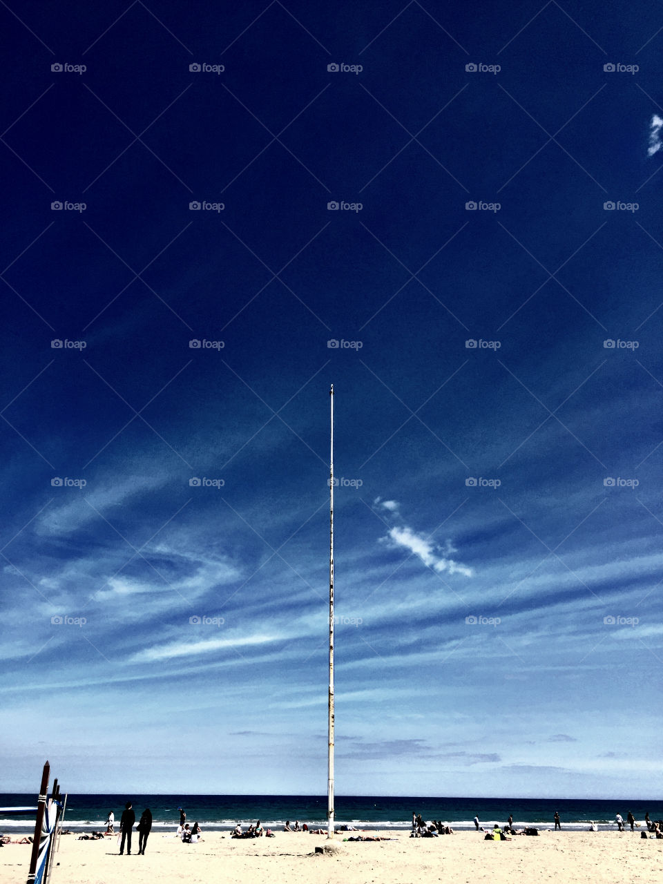 Sea skyline . Picture of blue sky with a pole in the center 