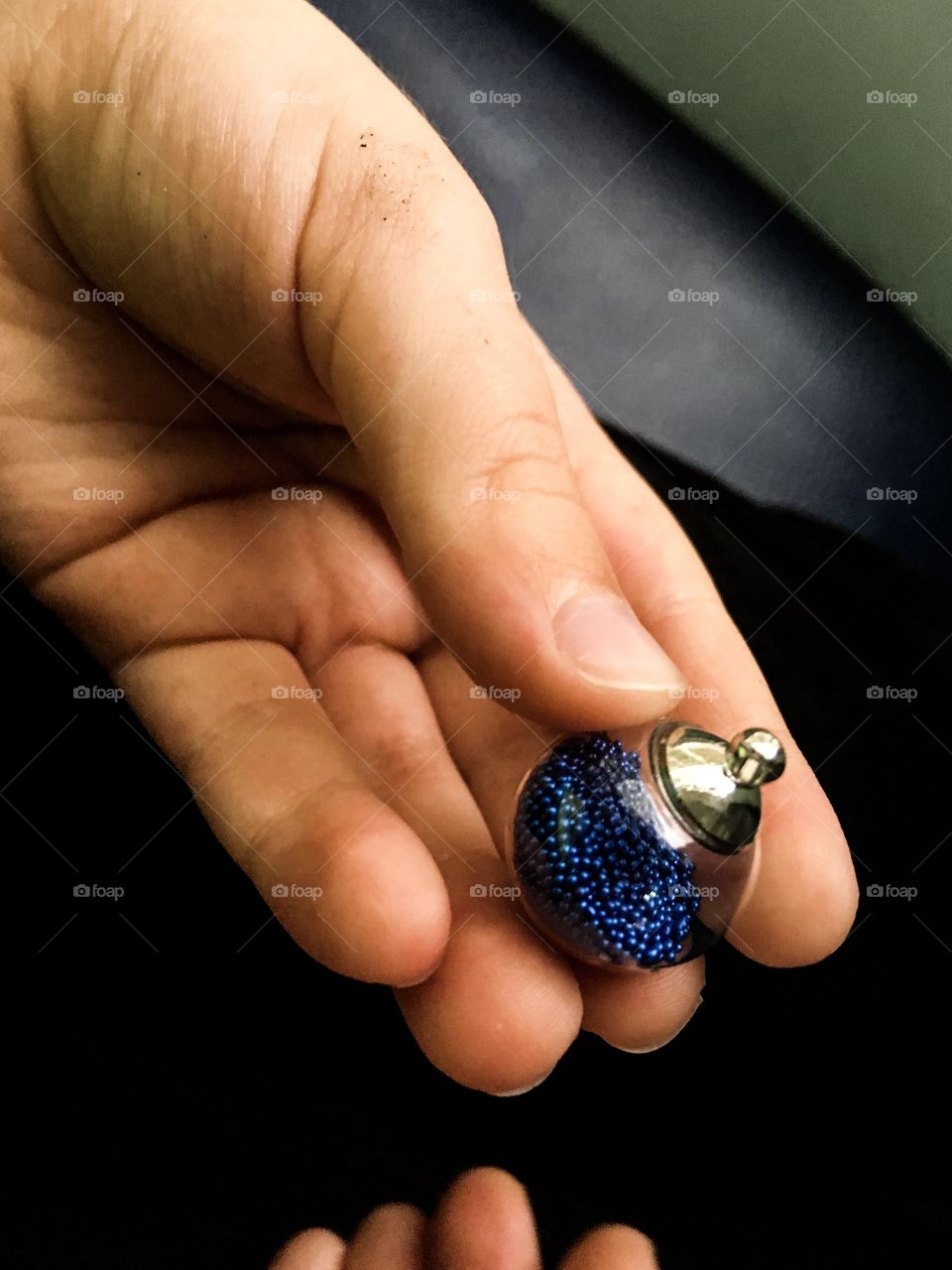 The creative blue bead in the child hand. 