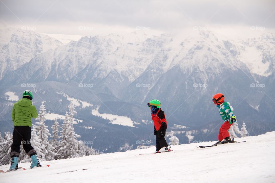 Woman and children skiing in Peak Postavarul, Poiana Brasov , Romania 
