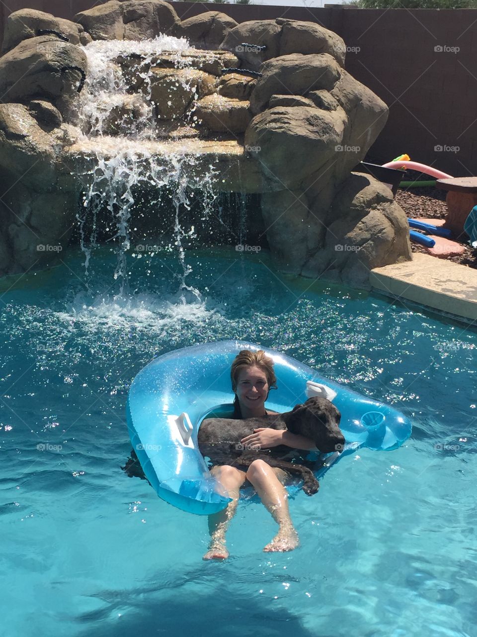 Summer Relaxing . We were trying to teach our Great Dane Dixie to be comfortable in the water, and on a float is where she best found it