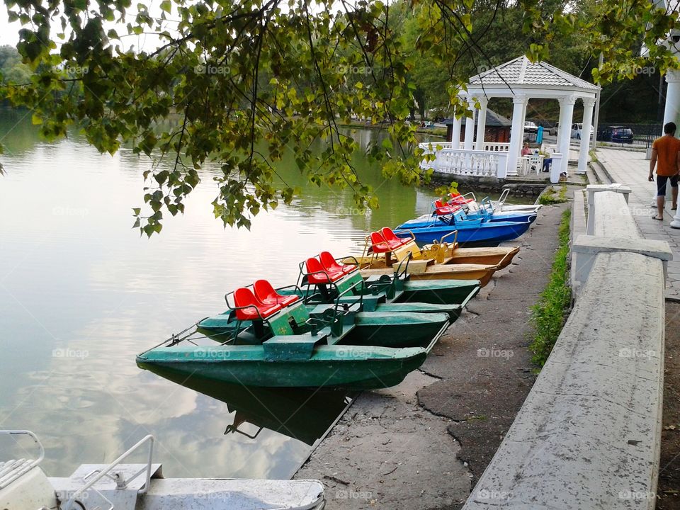 Landscape with a boat station on the lake of the city park.