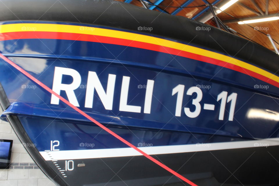 Close up of the side of an RNLI lifeboat in St.Ives lifeboat station, Cornwall, England. Crisp and vivid colours.