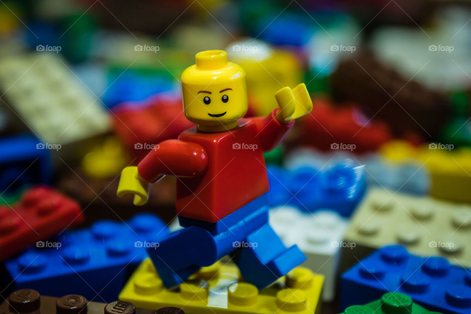 Lego man with lego background for children to play.