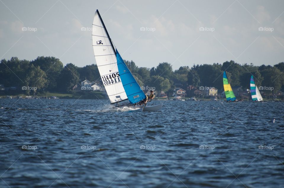 Taking pictures from our sailboat of the regatta that we came upon. Wind was perfect for sailing.