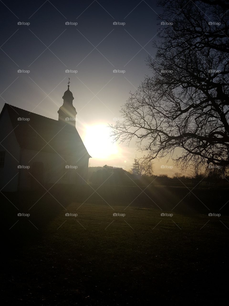 sundown behind a church