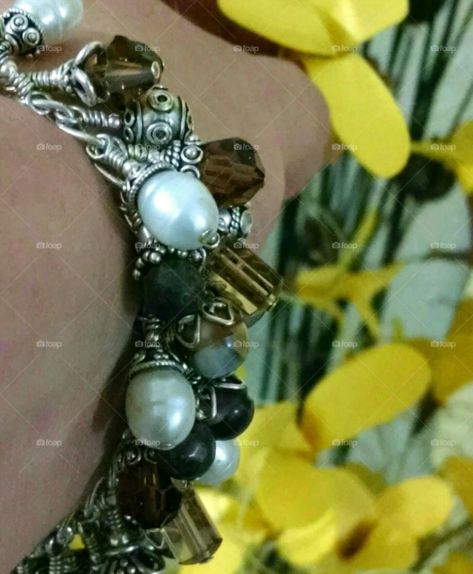 Handmade charm bracelet with pearls, crystals, natural stones and sterling silver.