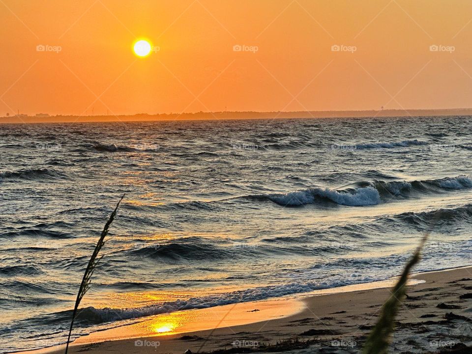 Vacation Series: Beach - Rolling waves from the Gulf of Mexico roll onto the sandy beach. Sun reflect off the waters surface