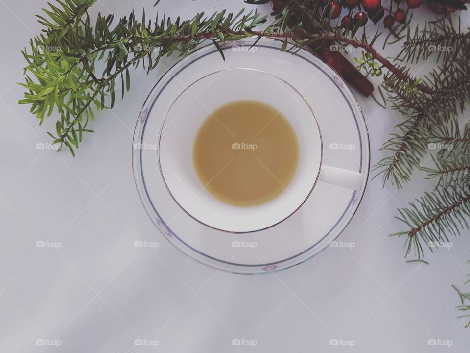 A cup of mint tea on a white table with earthy natural decor