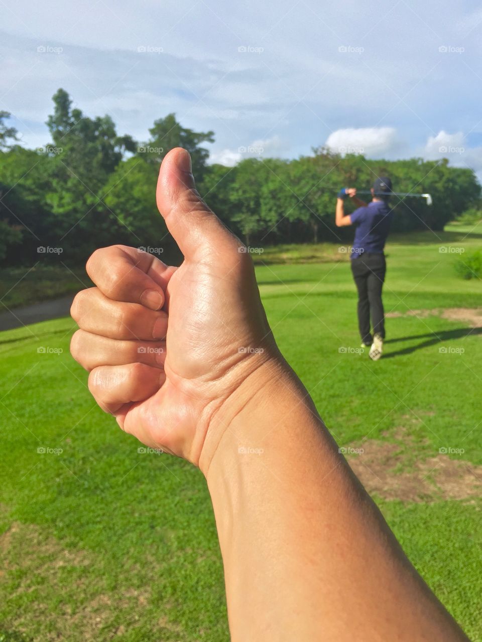 Thumb up for good start of the day at the golf course.
