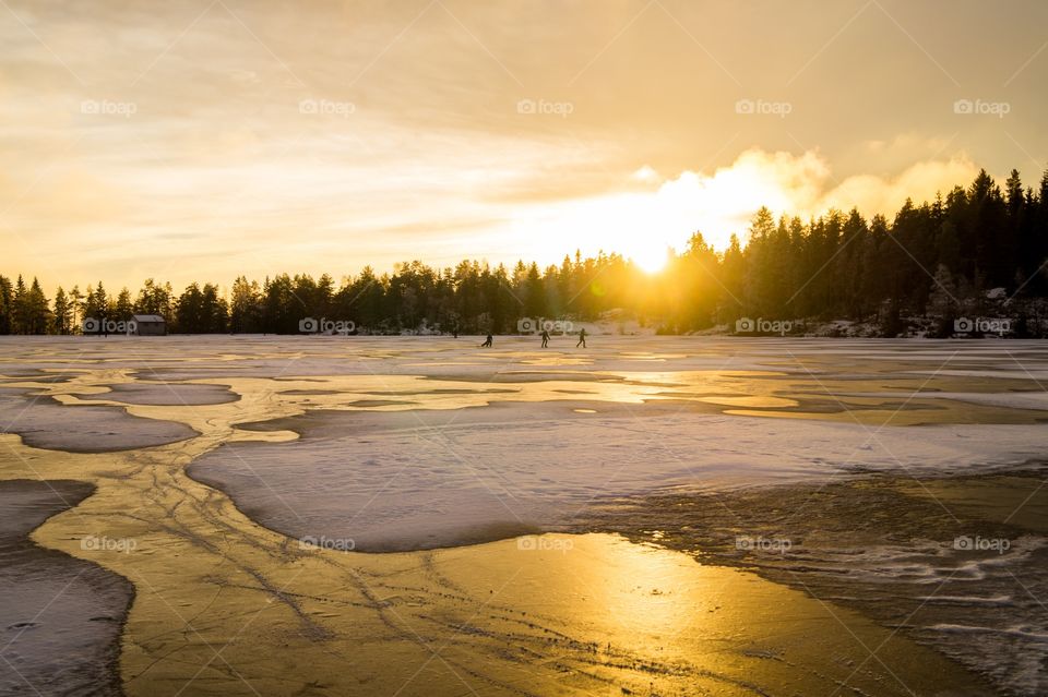 Children playing on a frozen lake. Nordmarka, Norway. 