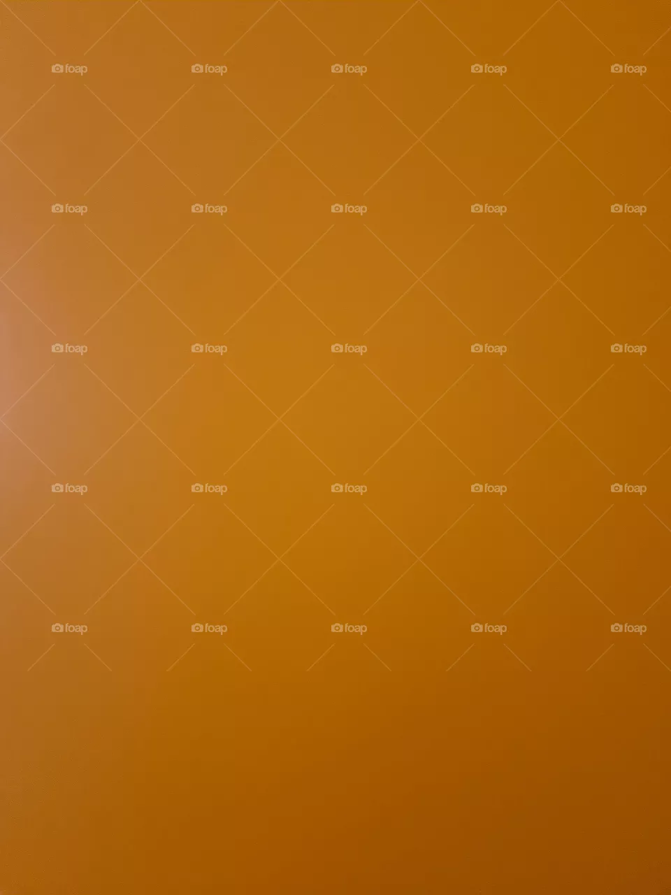Close up of an orange wooden door of a closet.