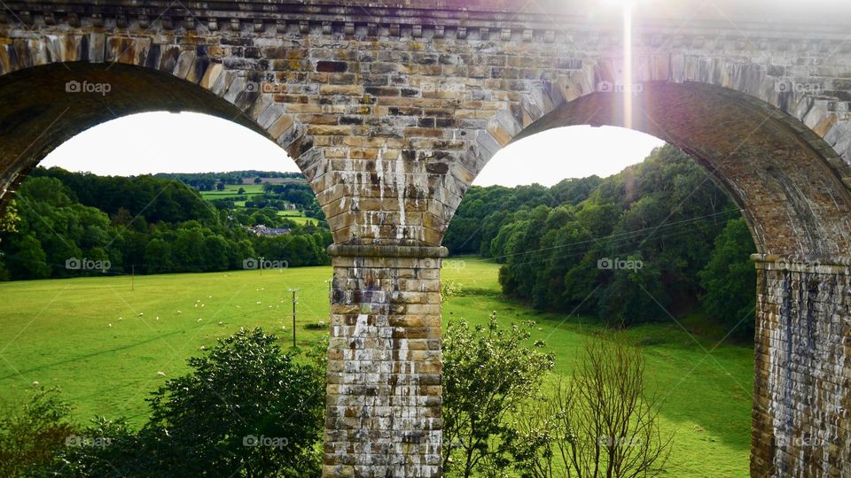 View over old aqueduct arches with sunlight 