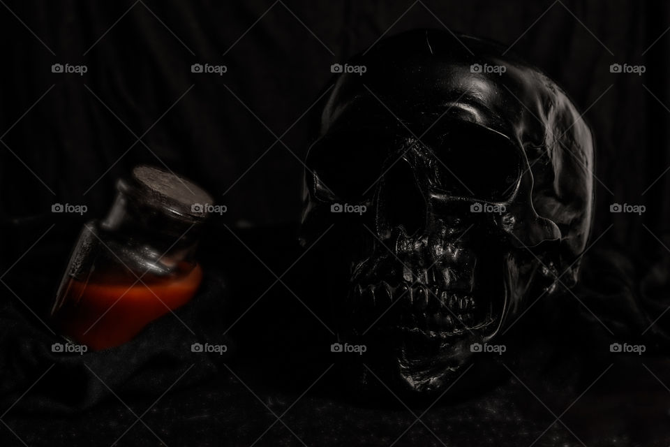Skull and bottle with red liquid