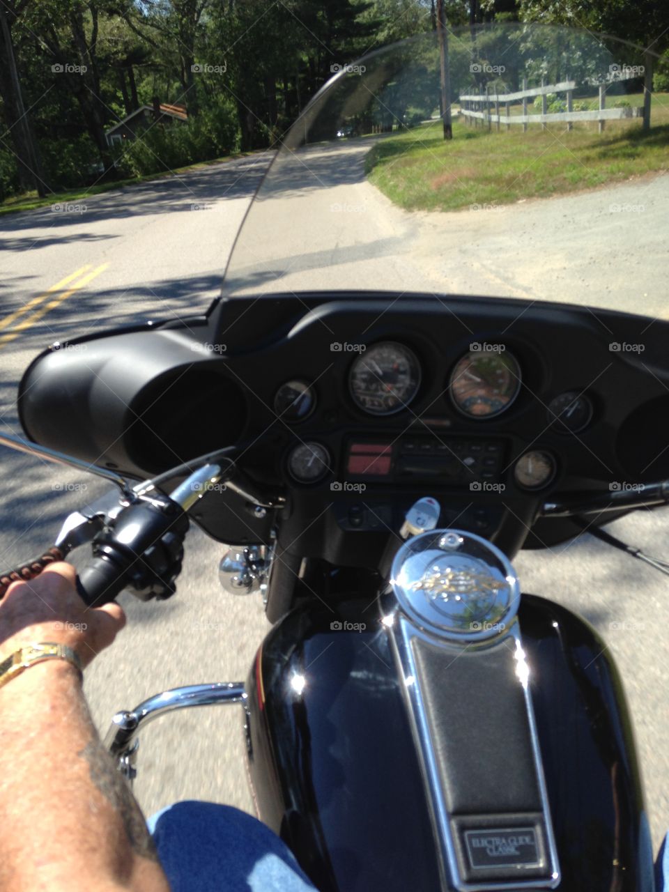 Riding Our Harley. A view over my husbands left shoulder as we drive through New England.