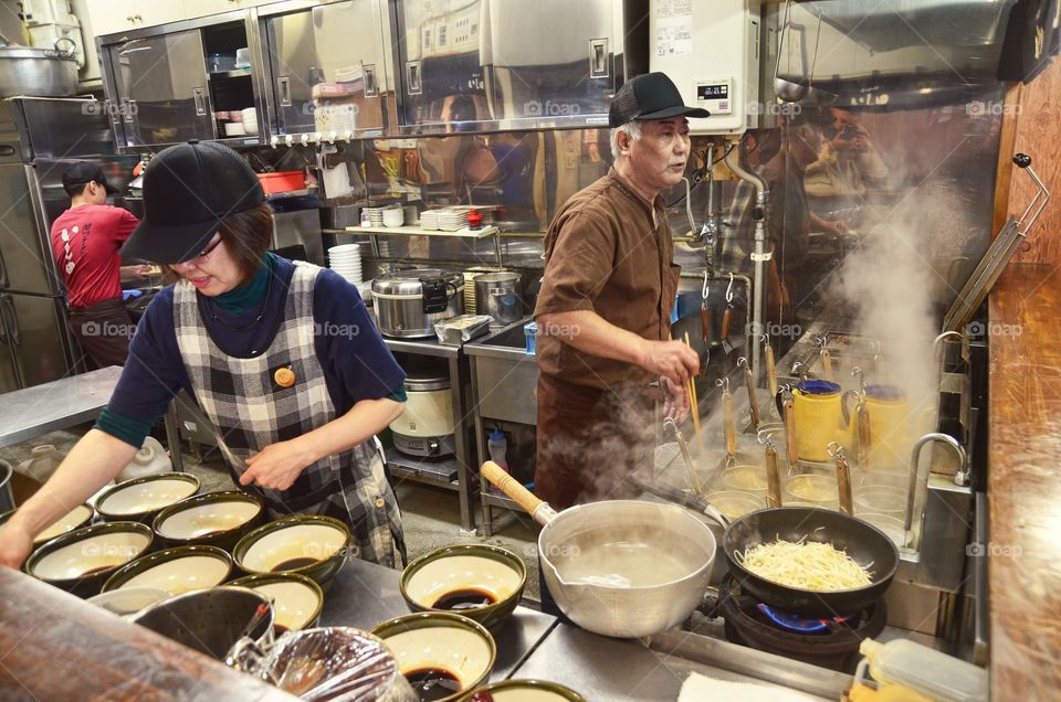 Chefs are preparing some bowls of ramen in Asahikawa Ramen Village