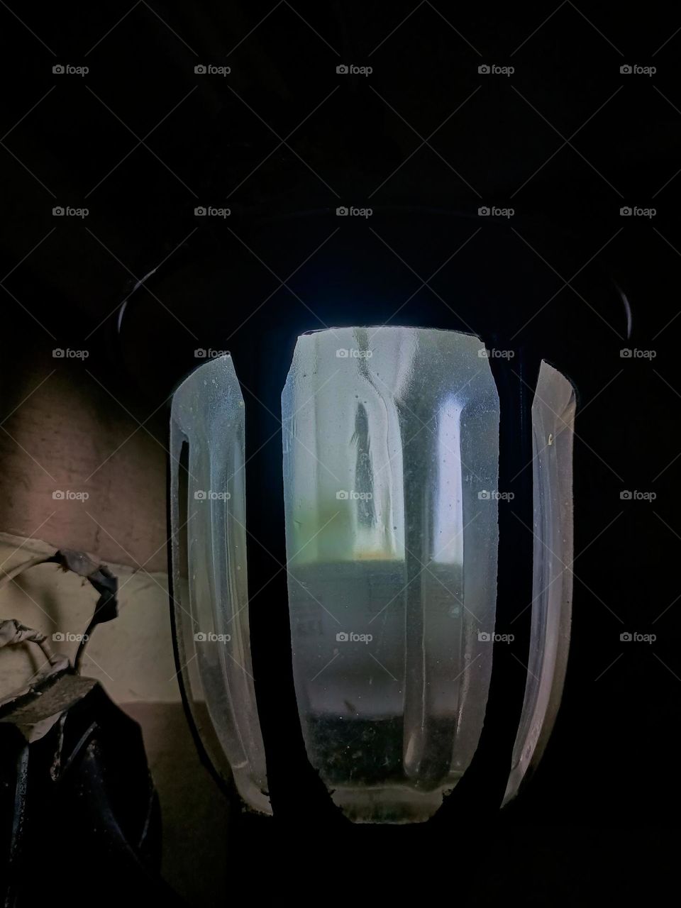 Warm white light lantern illuminating the front porch at night