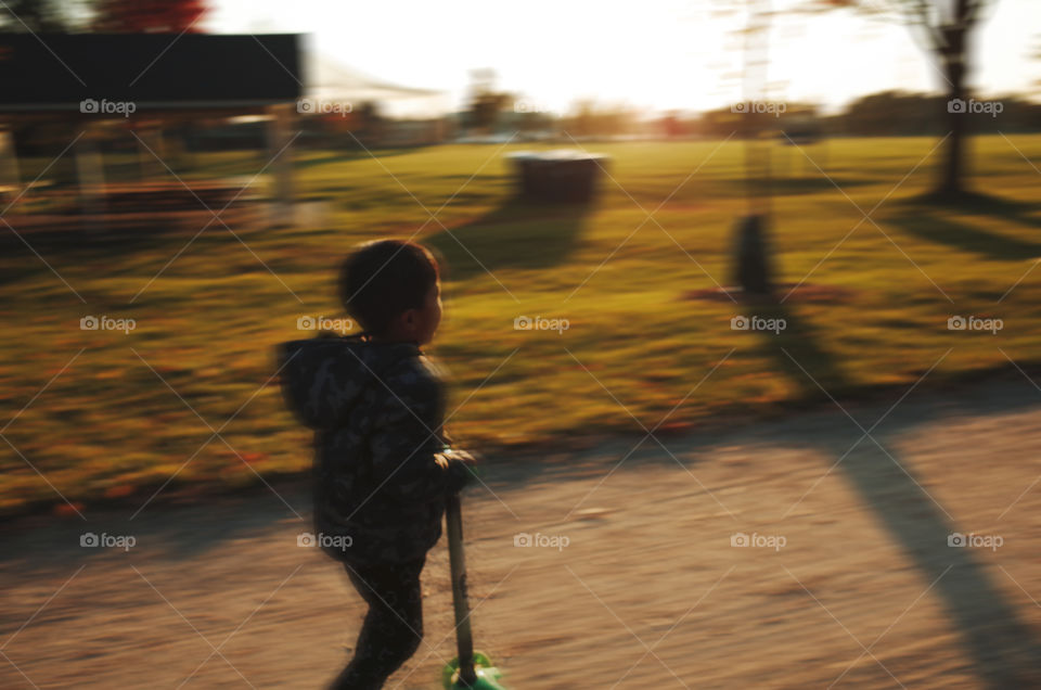 5 years old riding on a scooter